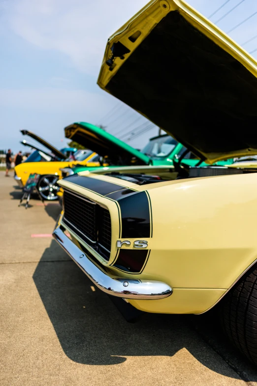 the back end of a yellow sports car at an auto show