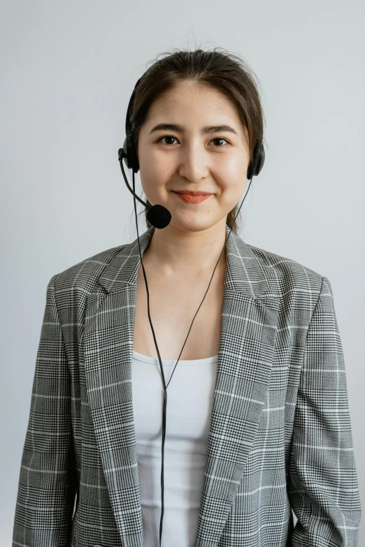 a woman with headphones wearing a suit jacket