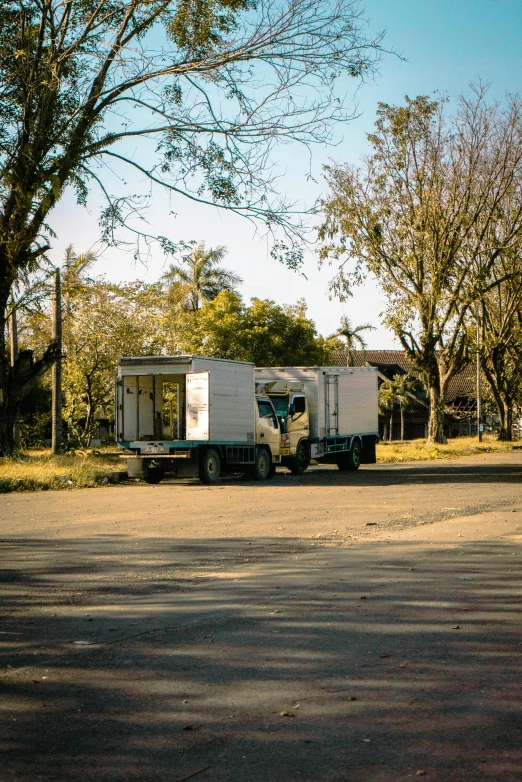 a truck with a mobile home behind it sits in the road