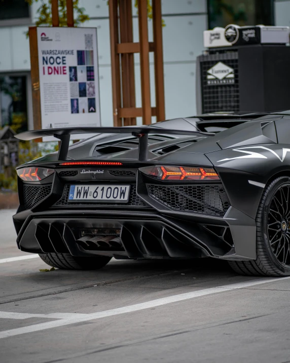 the black sports car with chrome accents driving down the road