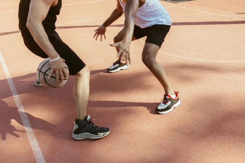 two people are on an indoor basketball court