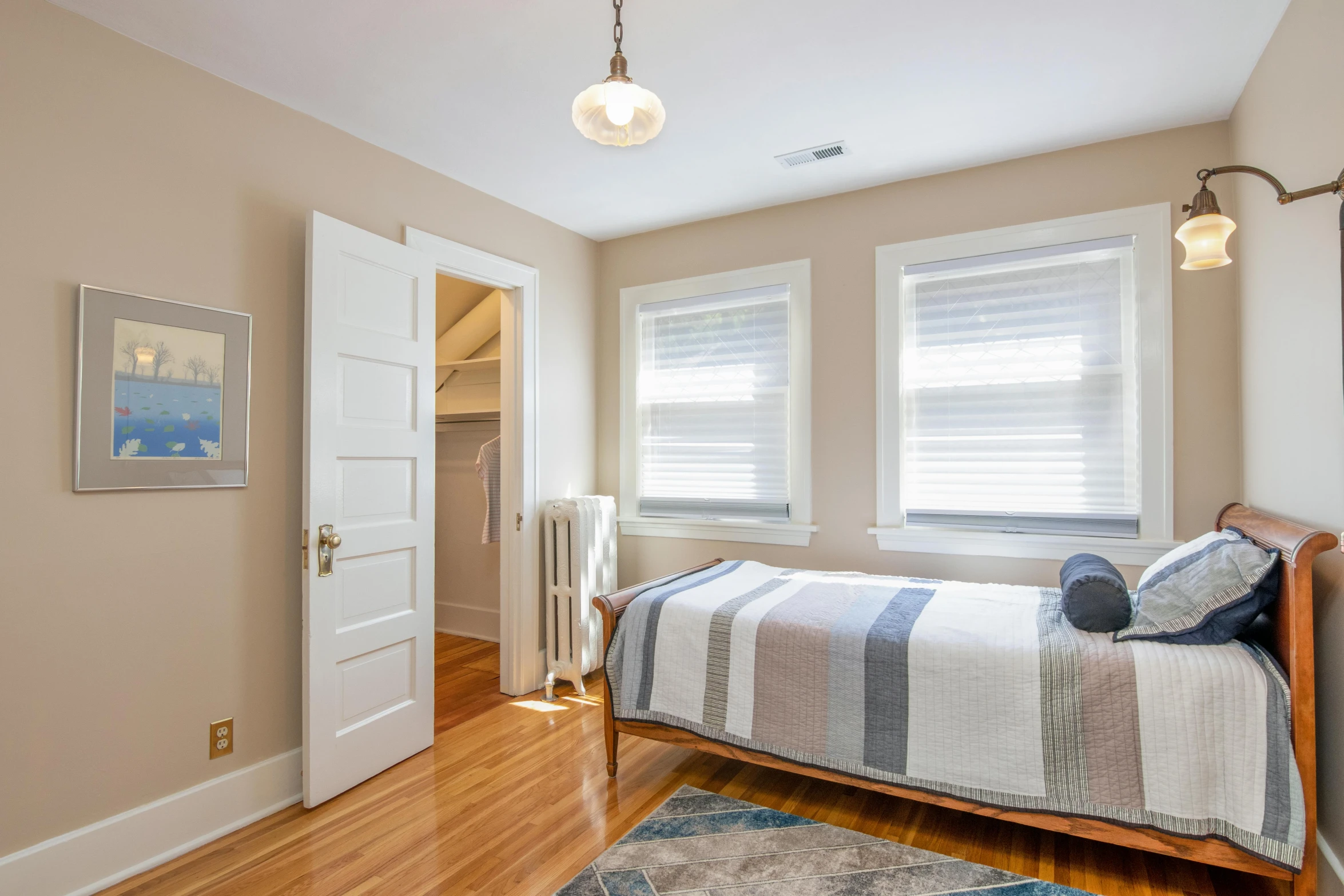 a bedroom with bed and dresser is shown