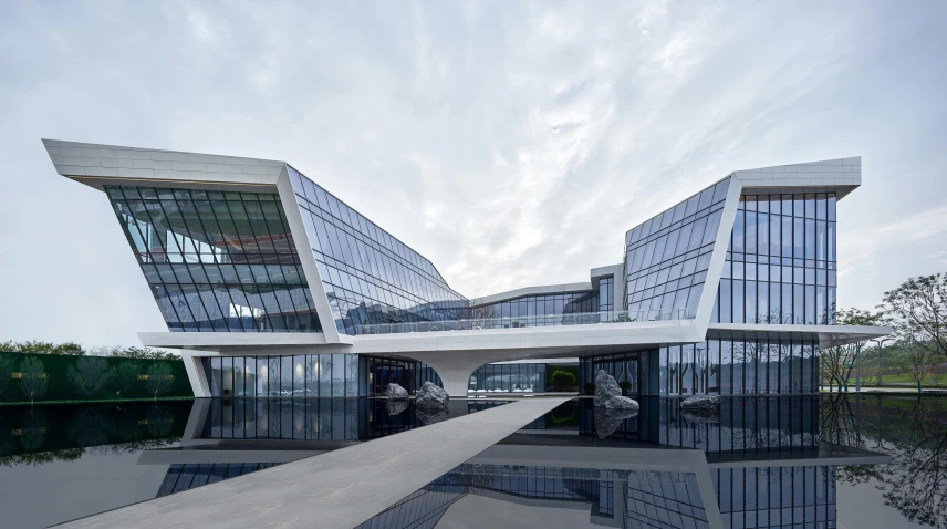 two large glass office buildings sit together on the waterfront