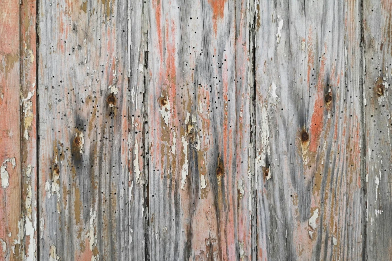 some paint and brown lines on a wooden fence