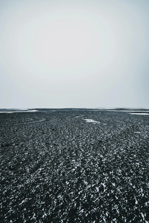 black and white po of the sea under cloudy skies