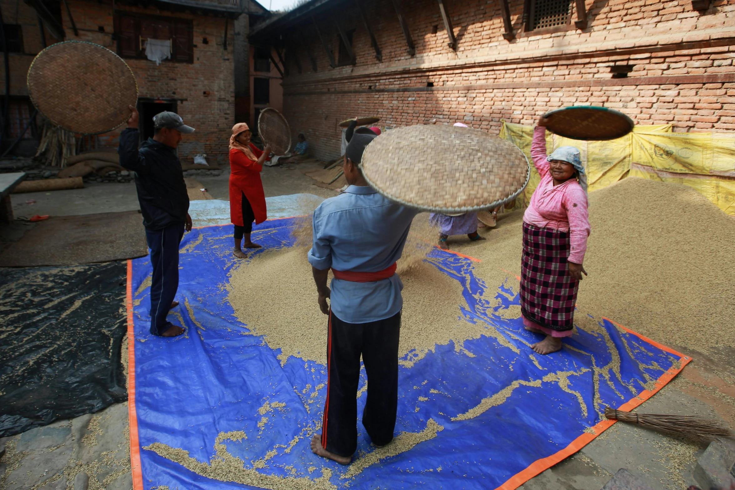 a man holding a large object on top of a blue mat