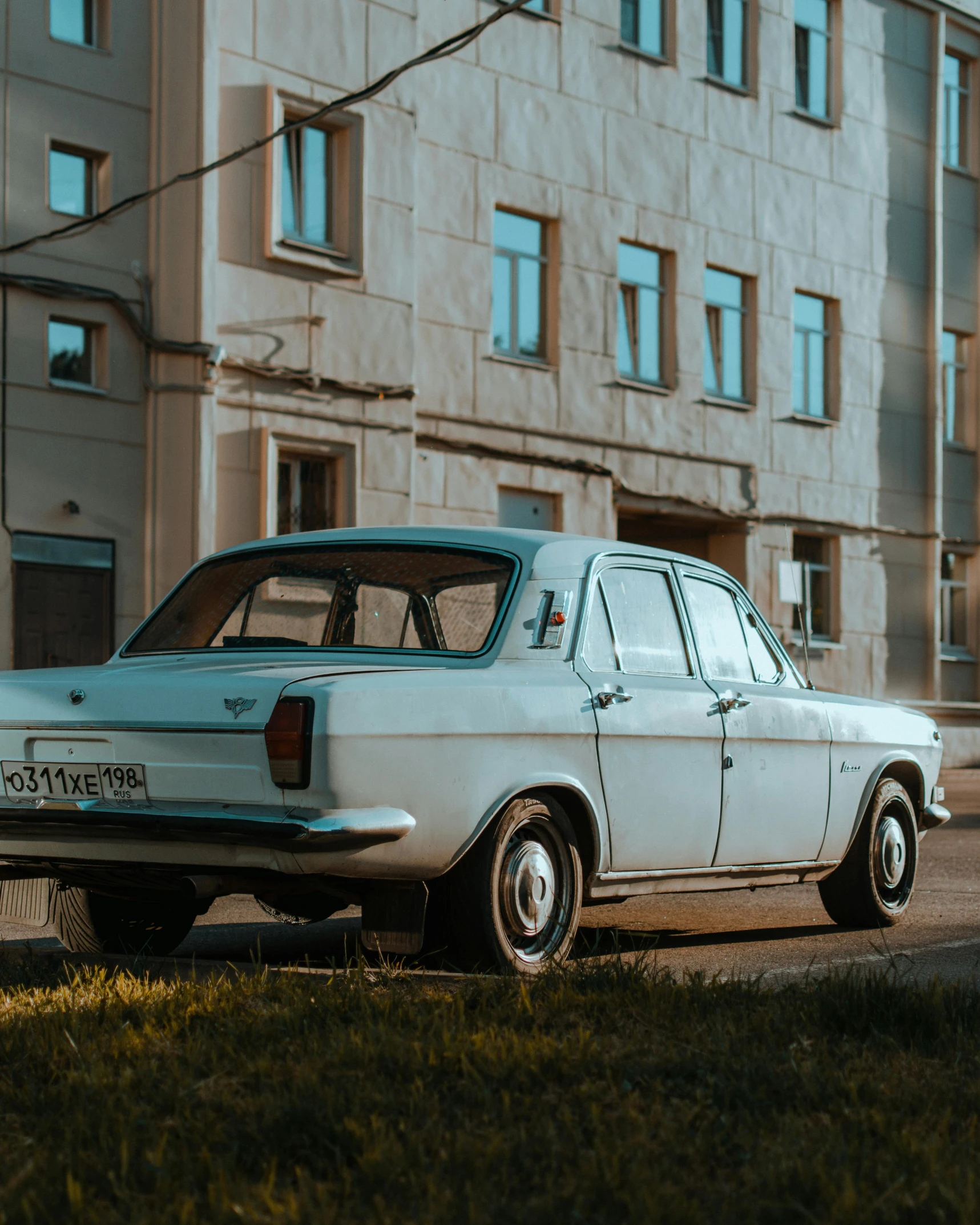 an old car sits parked in a field