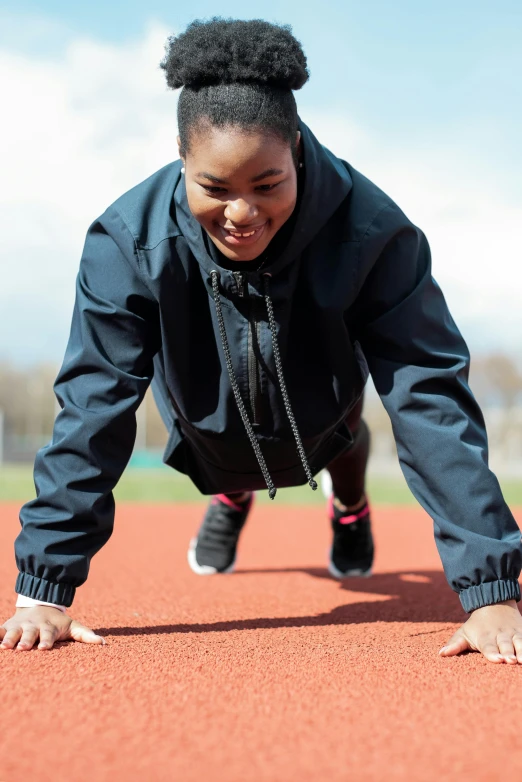 a  is stretching on the sideline of a baseball field