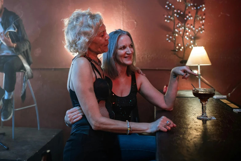 two women are sitting together in the room