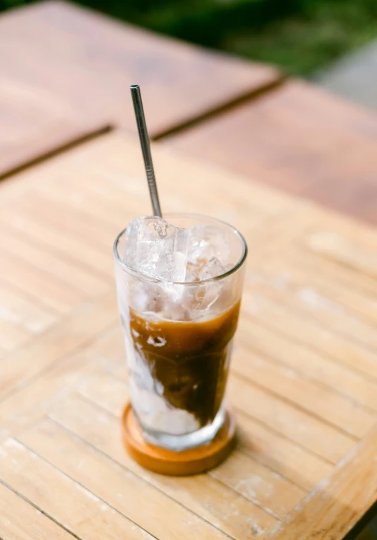 a drink in a glass with ice on top