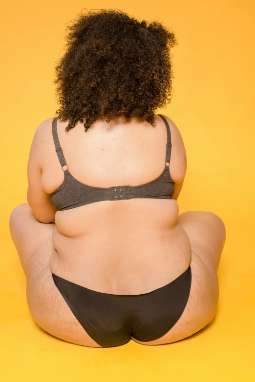 a woman sitting on the ground looking back