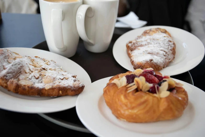 a variety of pastries and coffee at a coffee shop