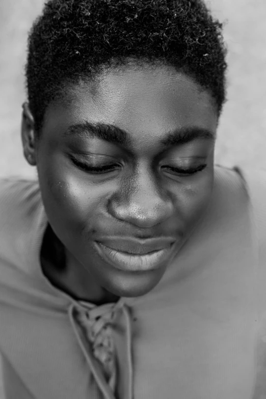 young black girl with closed eyes looking away from camera