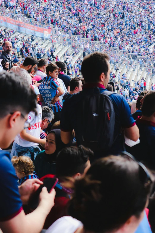 the crowd is sitting in the stands looking up