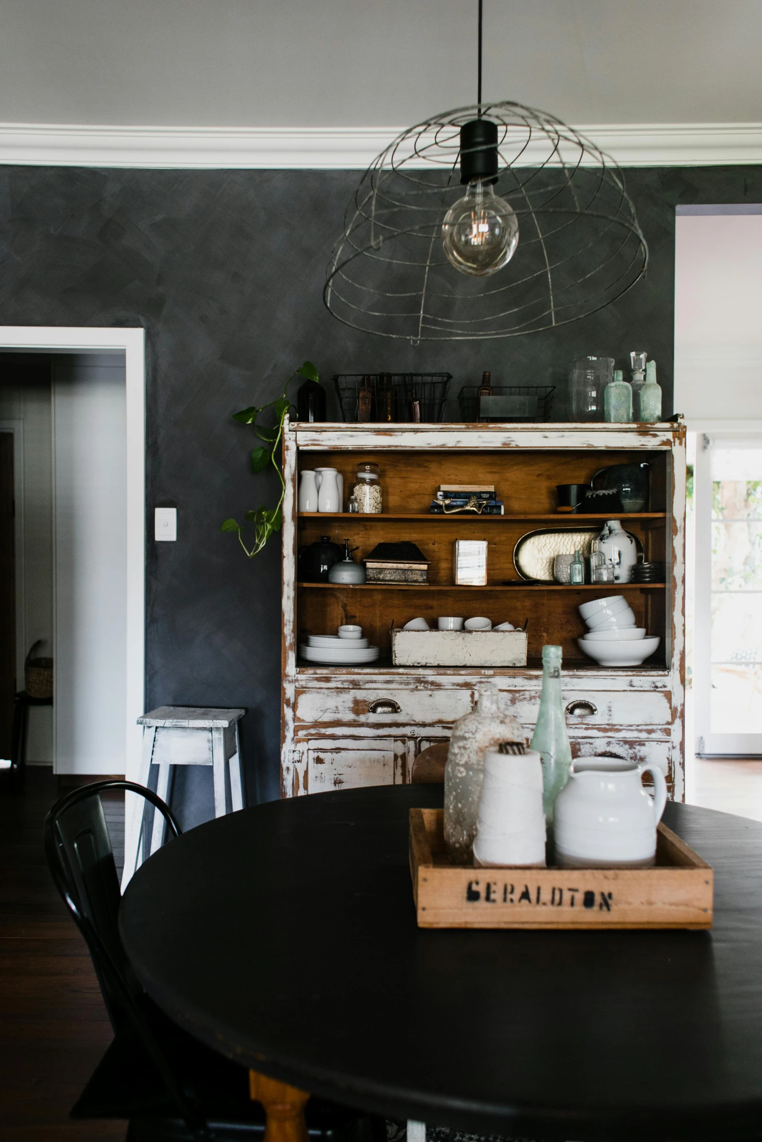 an open book sits on a kitchen table next to a light fixture