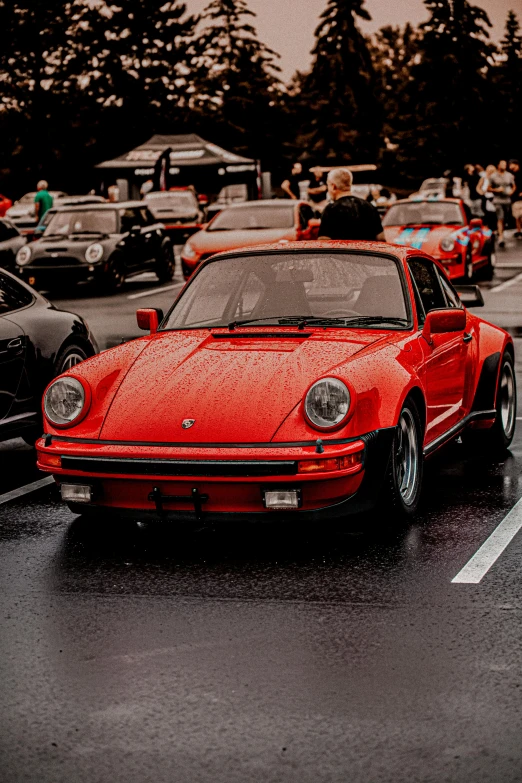 a very bright red porsche parked on the street