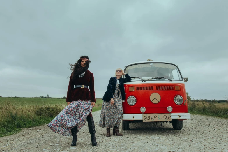 two people are walking by a red van