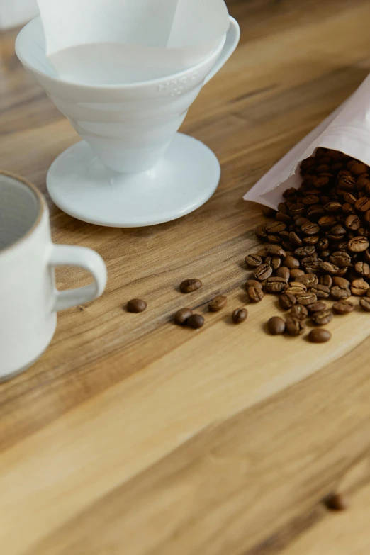 a bag of coffee next to coffee beans on a table