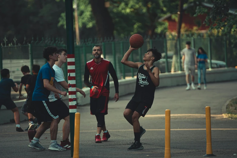 two men on opposite teams playing basketball in the park