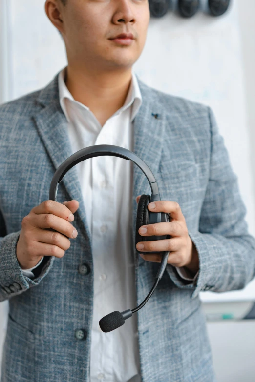 a man in a suit holding a headset