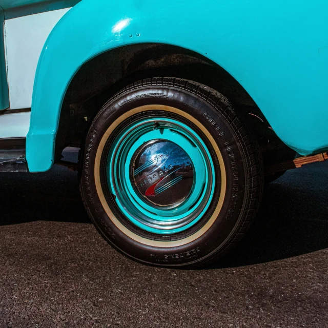 a close up of the front end of an old blue and white truck