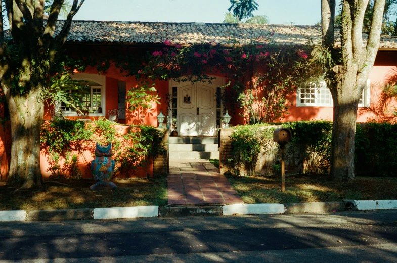 an orange building with two story plants surrounding it