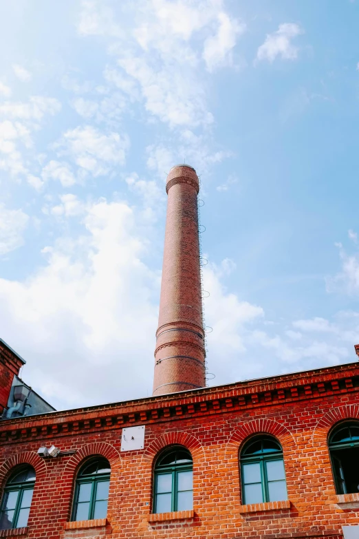 the brick building has green windows in it