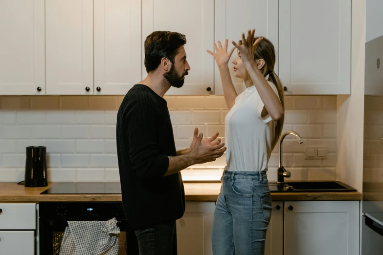 two people standing in a kitchen high five