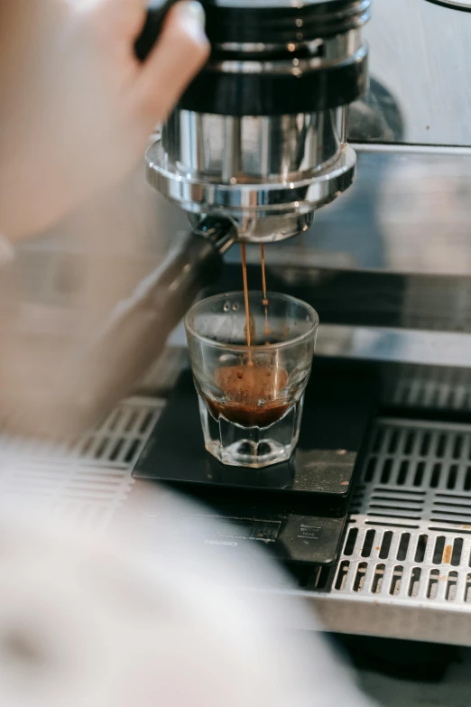 coffee being poured from a coffee maker into a glass