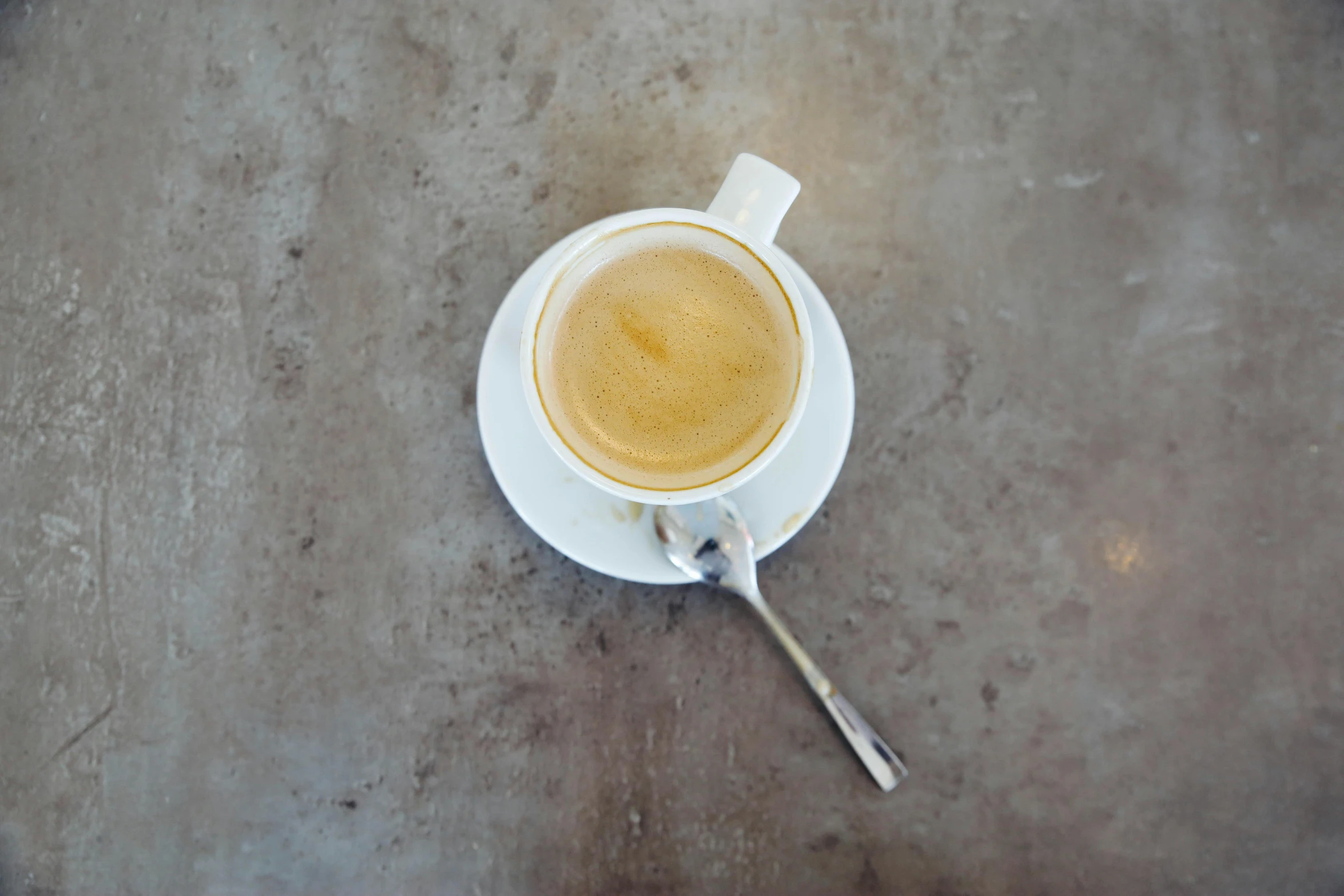 a mug with the spoon on a saucer