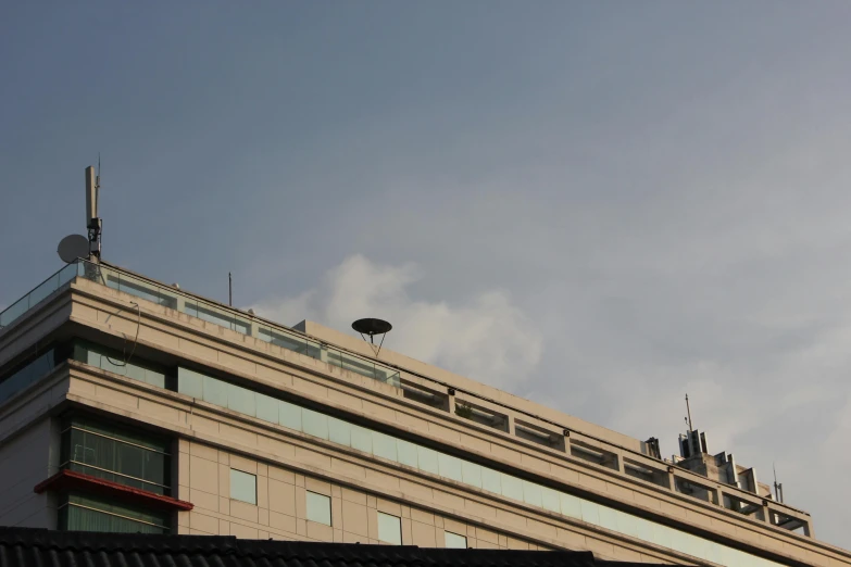 the building has a tower and several satellite dishes on top