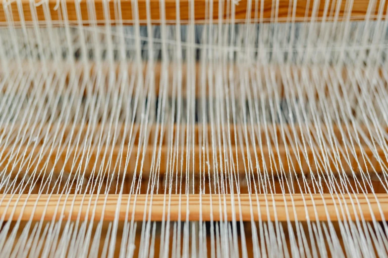 closeup of a loom of yarn with very long strands