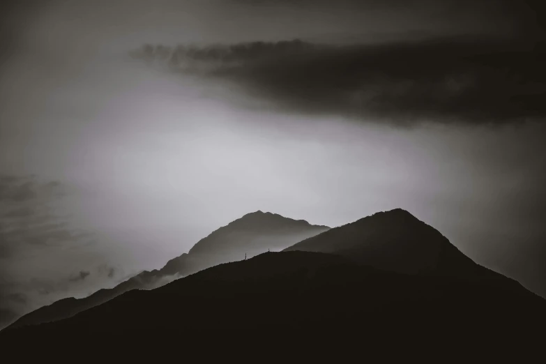 mountains at the foot of storm clouds, black and white