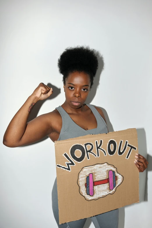 a black woman posing while holding a box