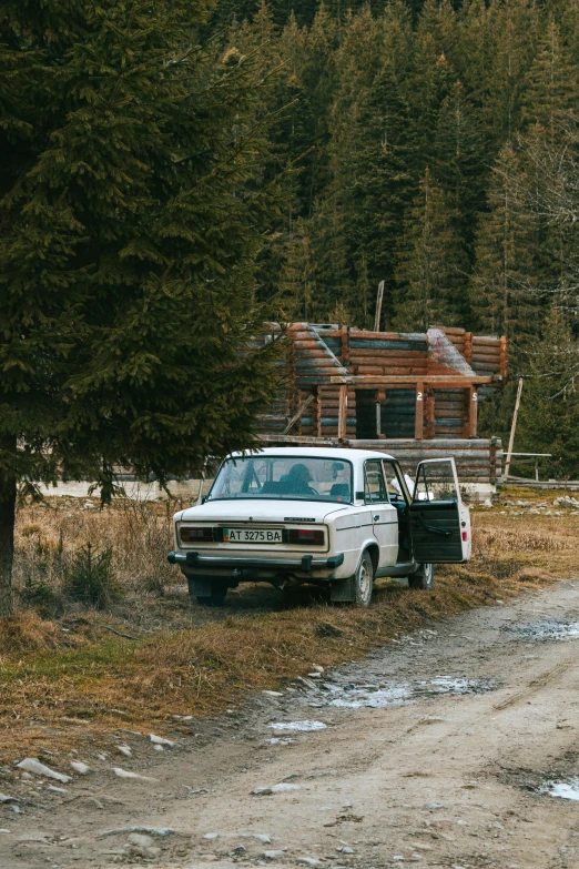 a truck with the back door open parked next to a house