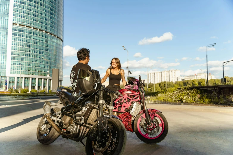 a woman with glasses is standing behind a motorcycle