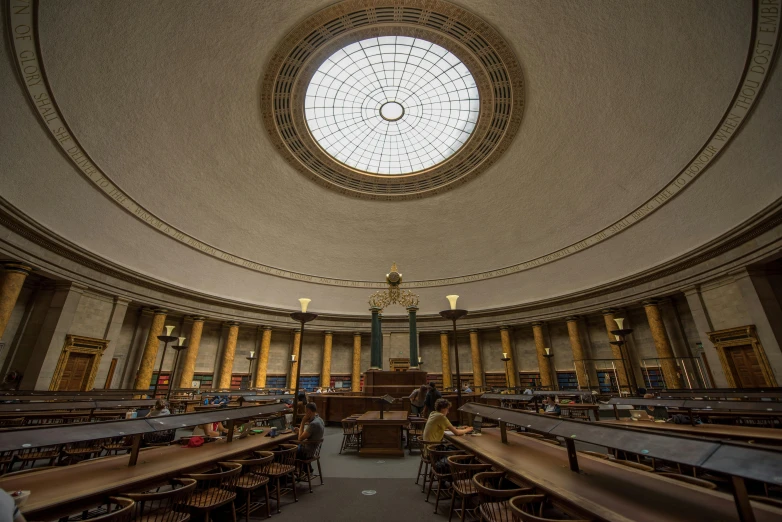 a large circular ceiling with windows and tables on the floor