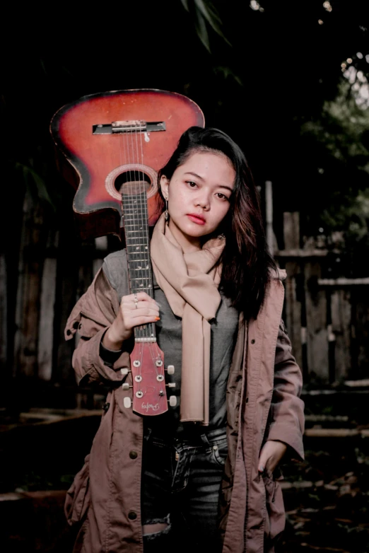 woman holding an acoustic guitar shaped like a guitar