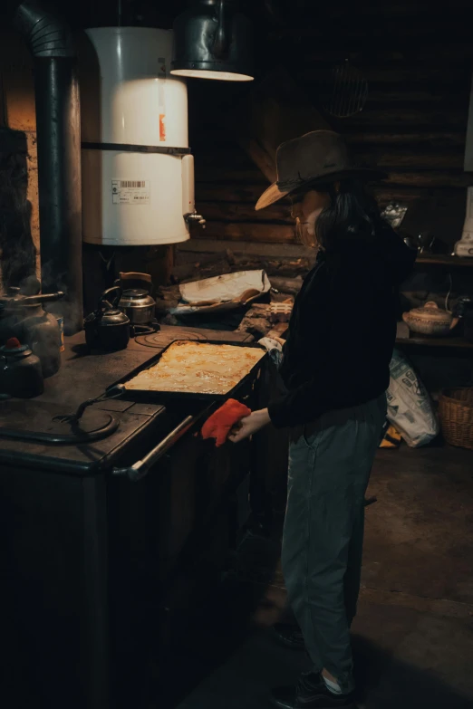 a woman is standing in the middle of a kitchen preparing food