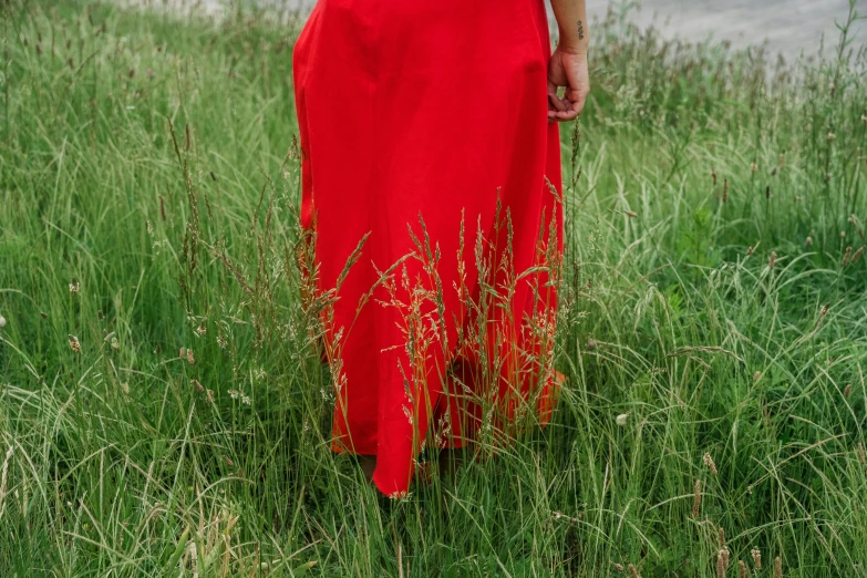 a red dress that is hanging from a pole