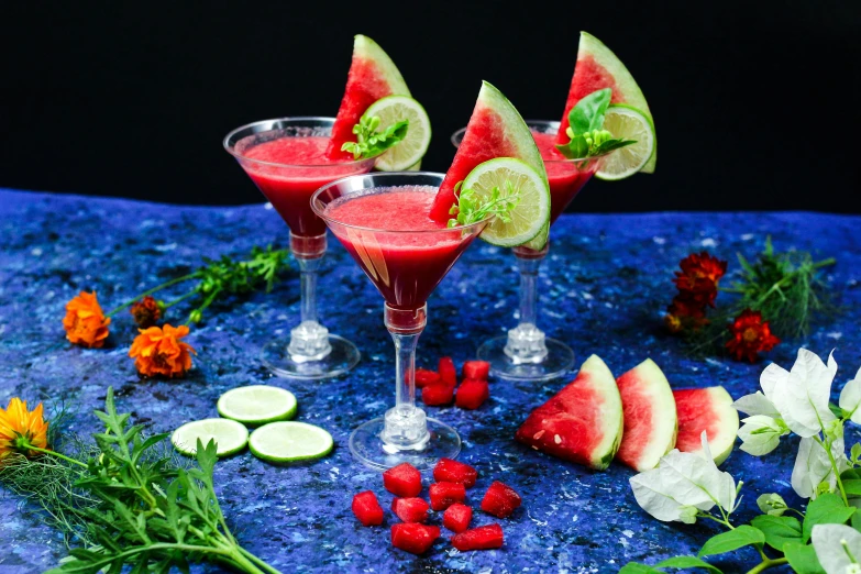 a group of small glass filled with a watermelon martini