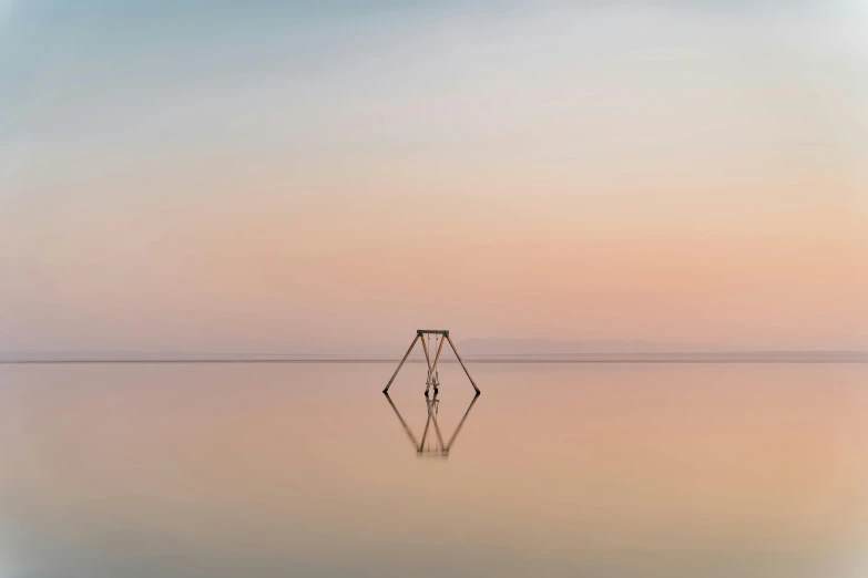 the shadow in the water shows the boat standing upright and moving