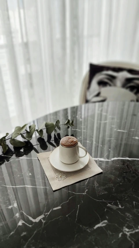 there is a teacup on a marble table