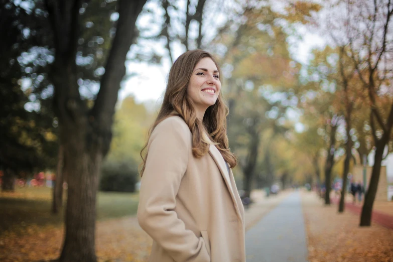 a beautiful young woman standing in the woods