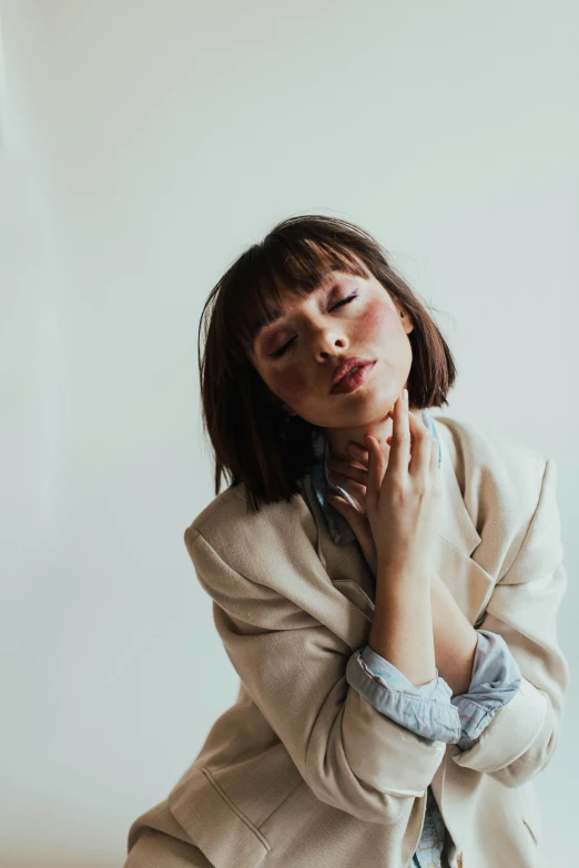 a young woman in a blazer posing for a po