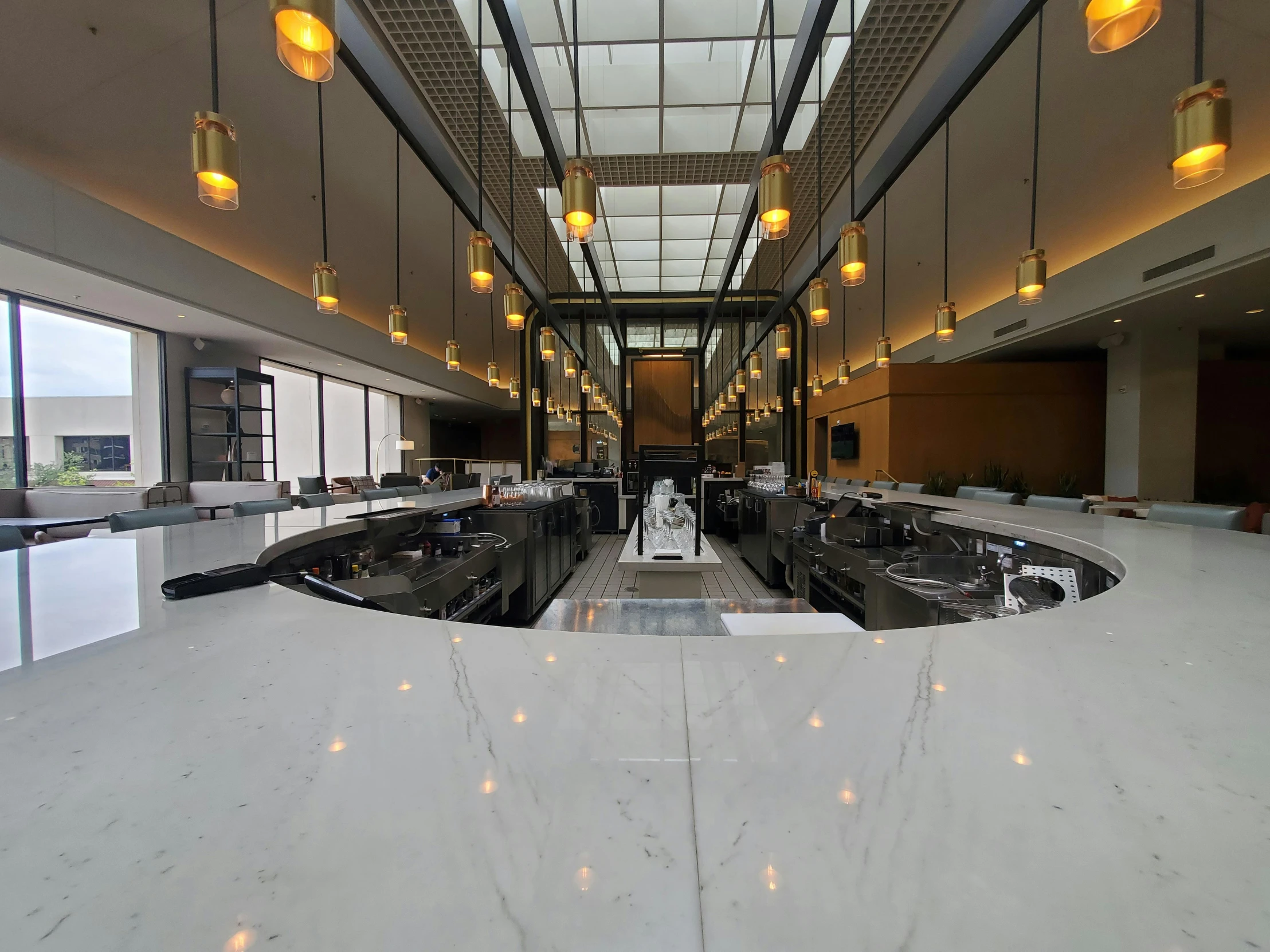 an empty dining room with lights and a mirror