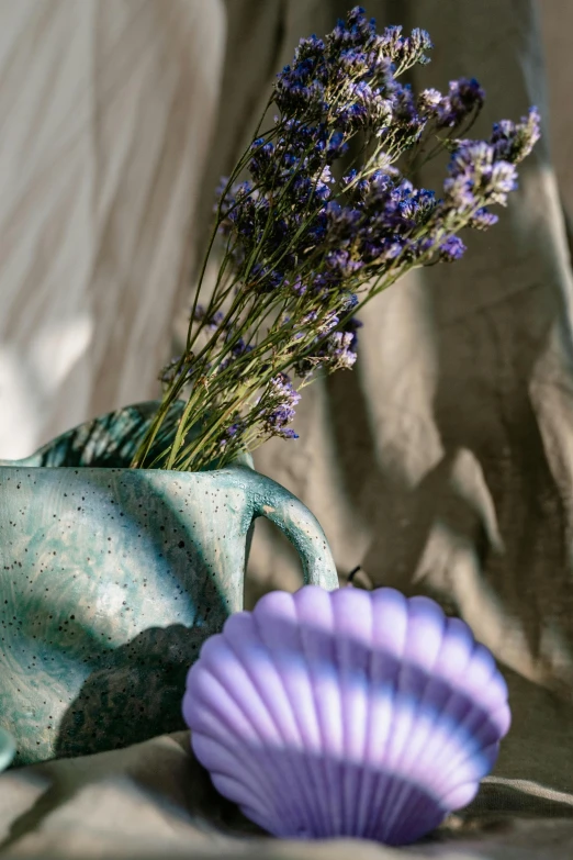 a vase with some small purple flowers in it