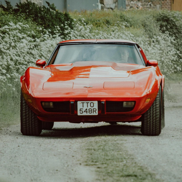 a red sports car is parked in the sand