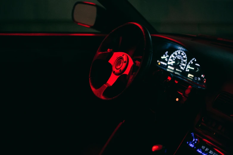 a dark po of a car dashboard showing its interior