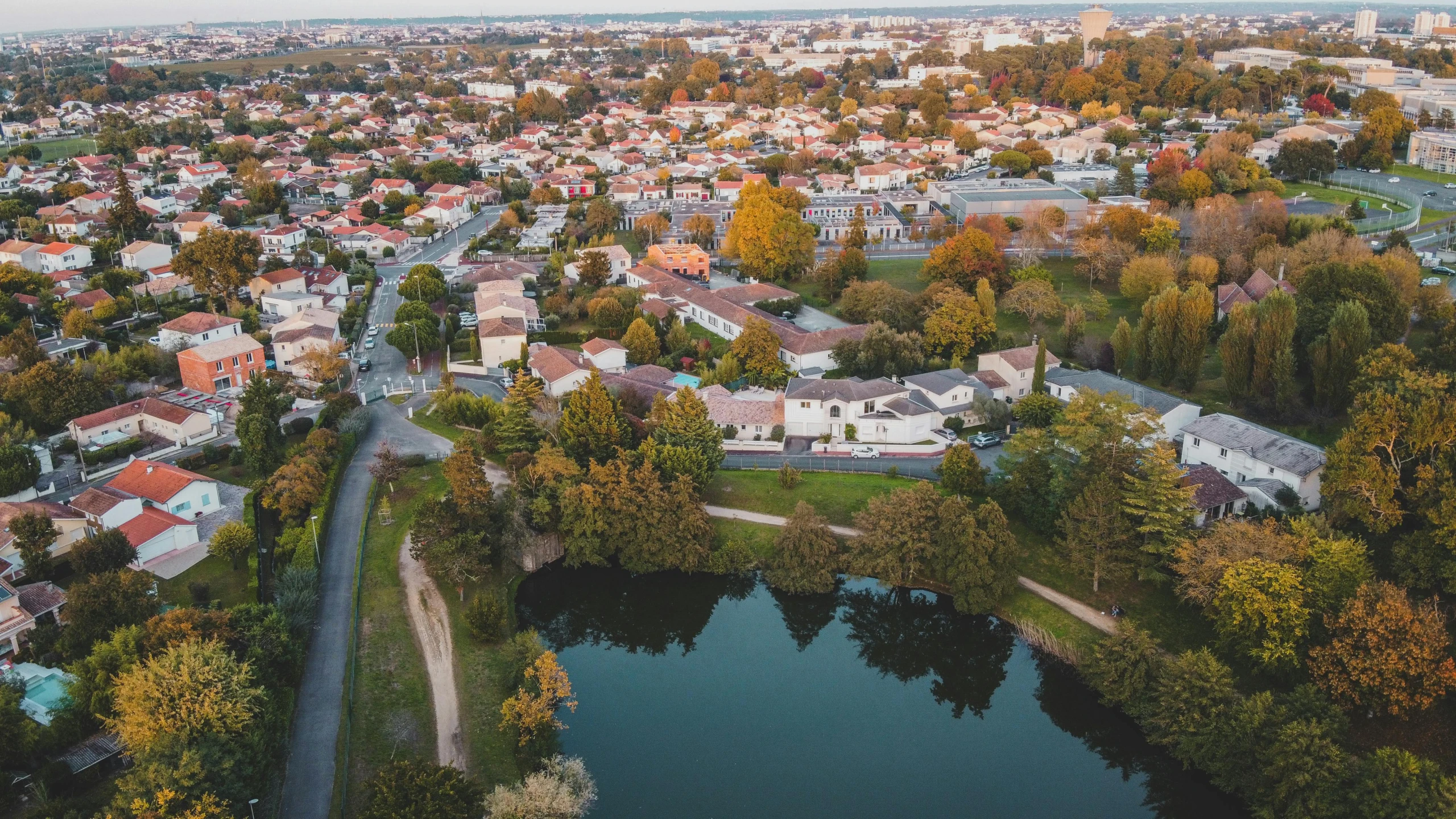 an aerial view of the suburbs and houses next to the lake